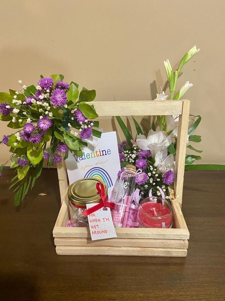 a wooden box filled with flowers and candles