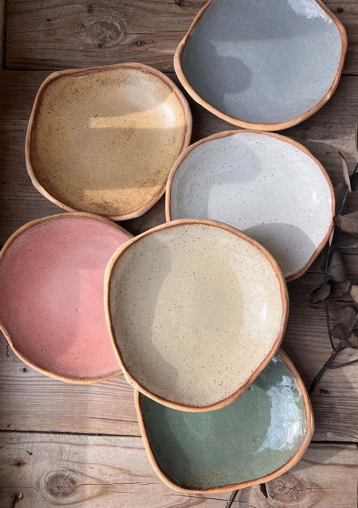 four bowls sitting on top of a wooden table