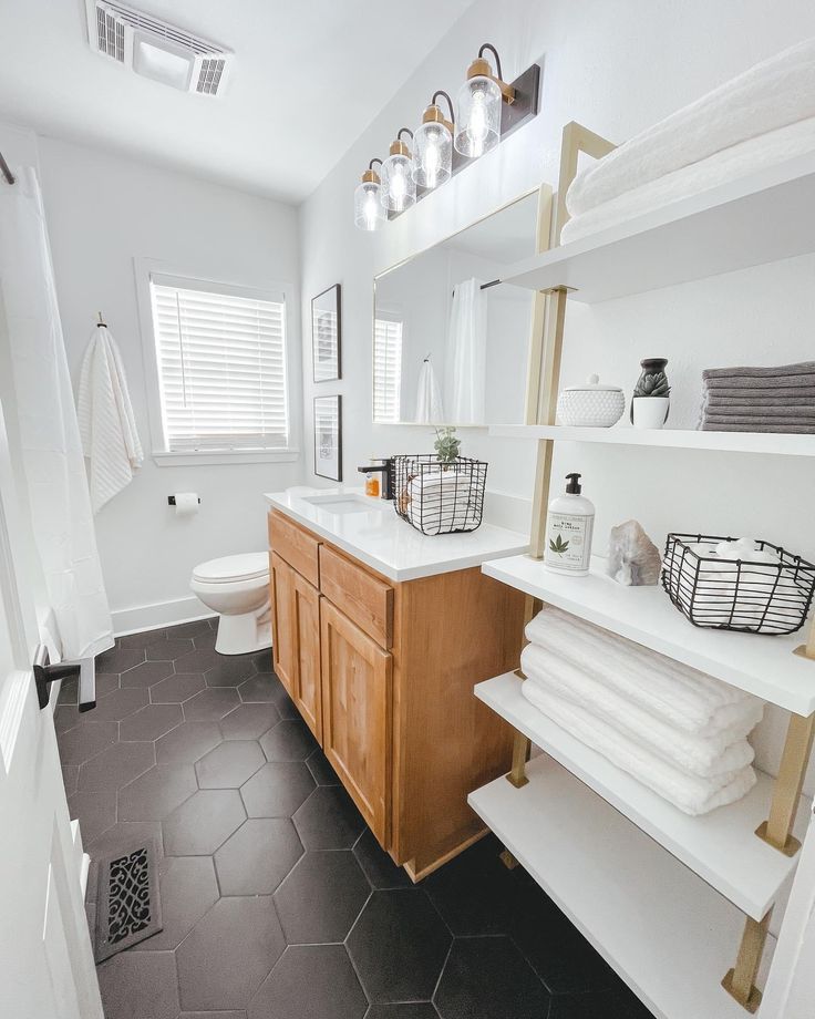 a bathroom with black and white tile flooring