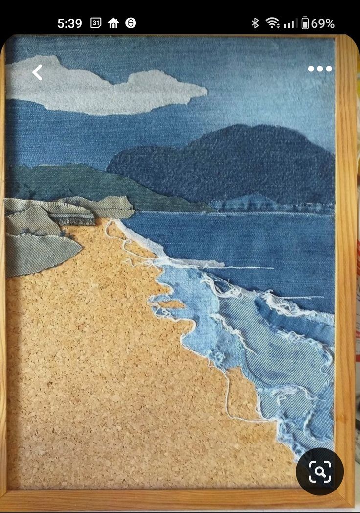 an image of a beach scene made out of paper and wood framed in a wooden frame