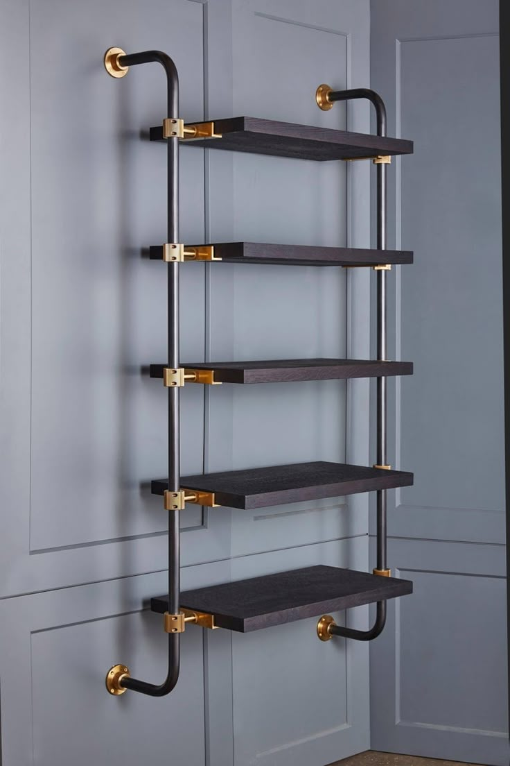 the shelf is made out of wood and has two brass handles on each side, along with three black shelves