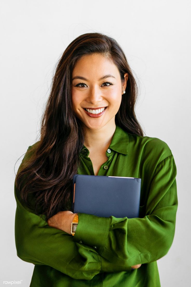 a woman smiling while holding a tablet computer