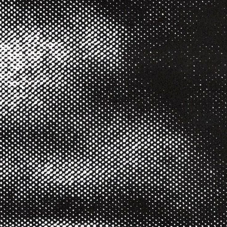 an abstract black and white background with small dots in the center, as if it were woven on fabric