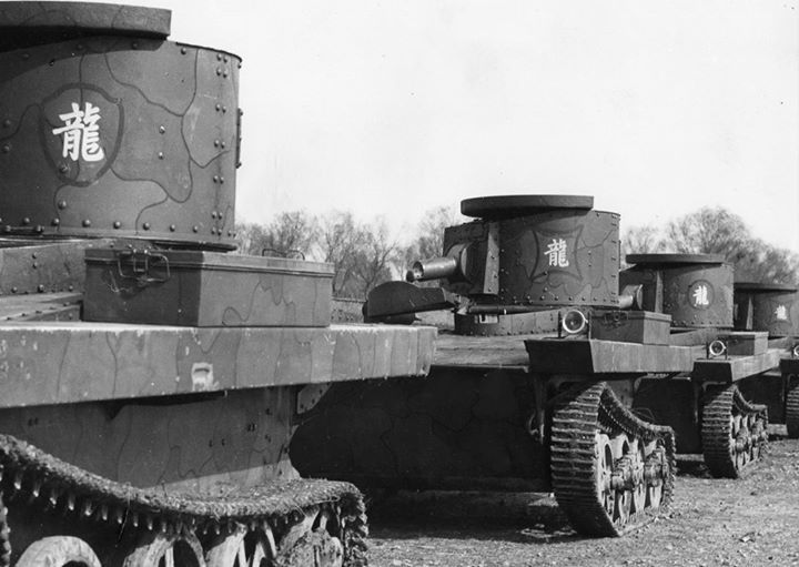 several tanks are lined up on the ground in black and white, with chinese characters painted on them