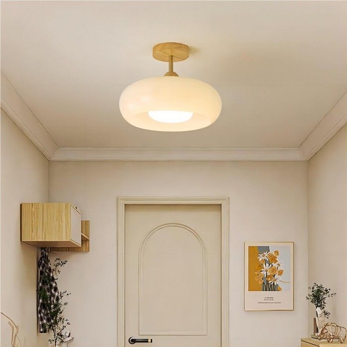 a bathroom with a sink, toilet and mirror on the wall next to a door