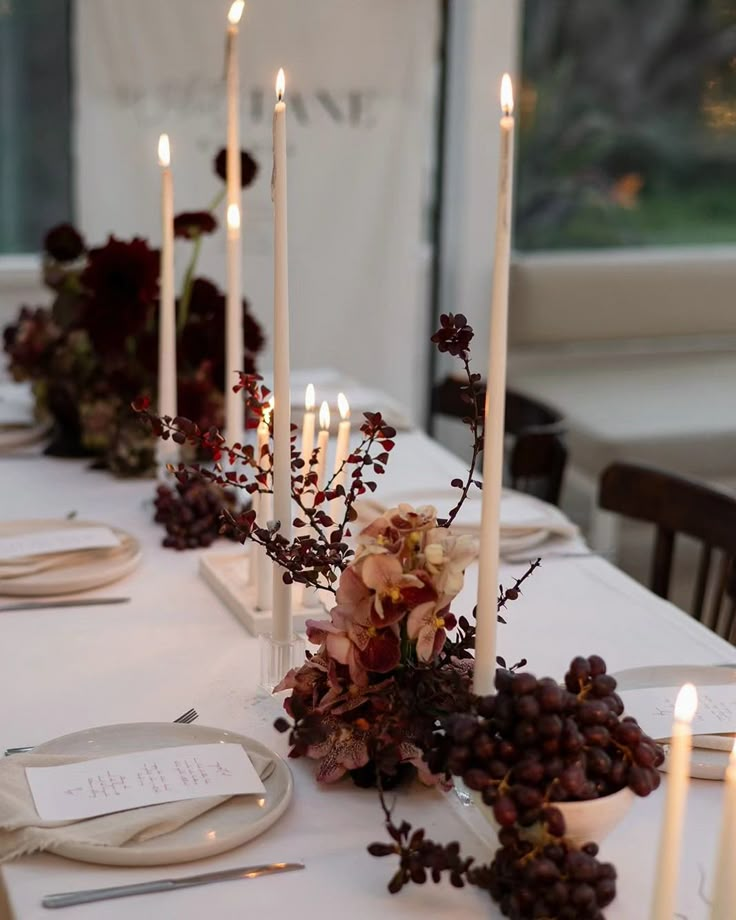 the table is set with candles and place settings