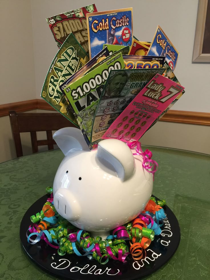 a white piggy bank sitting on top of a table filled with candy and candies