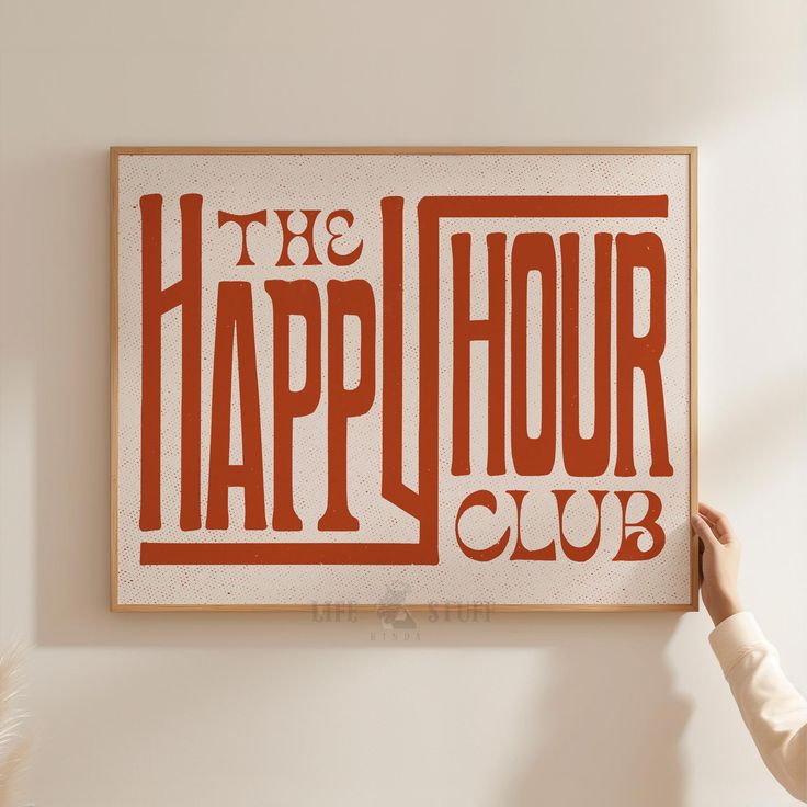 a person holding up a sign that says the happy hour club in red and white