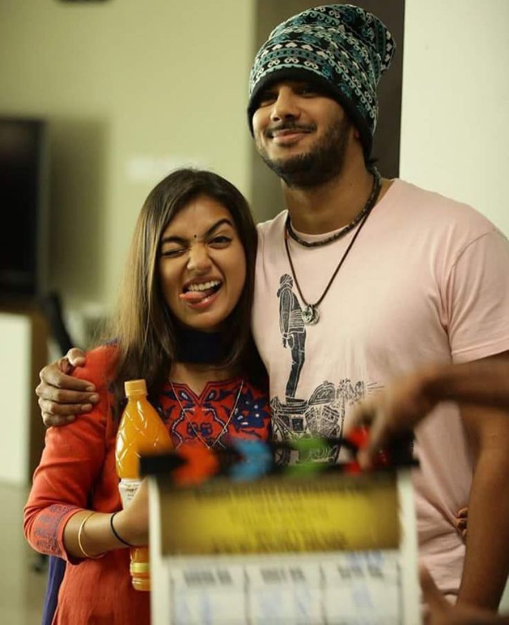 a man standing next to a woman holding a box