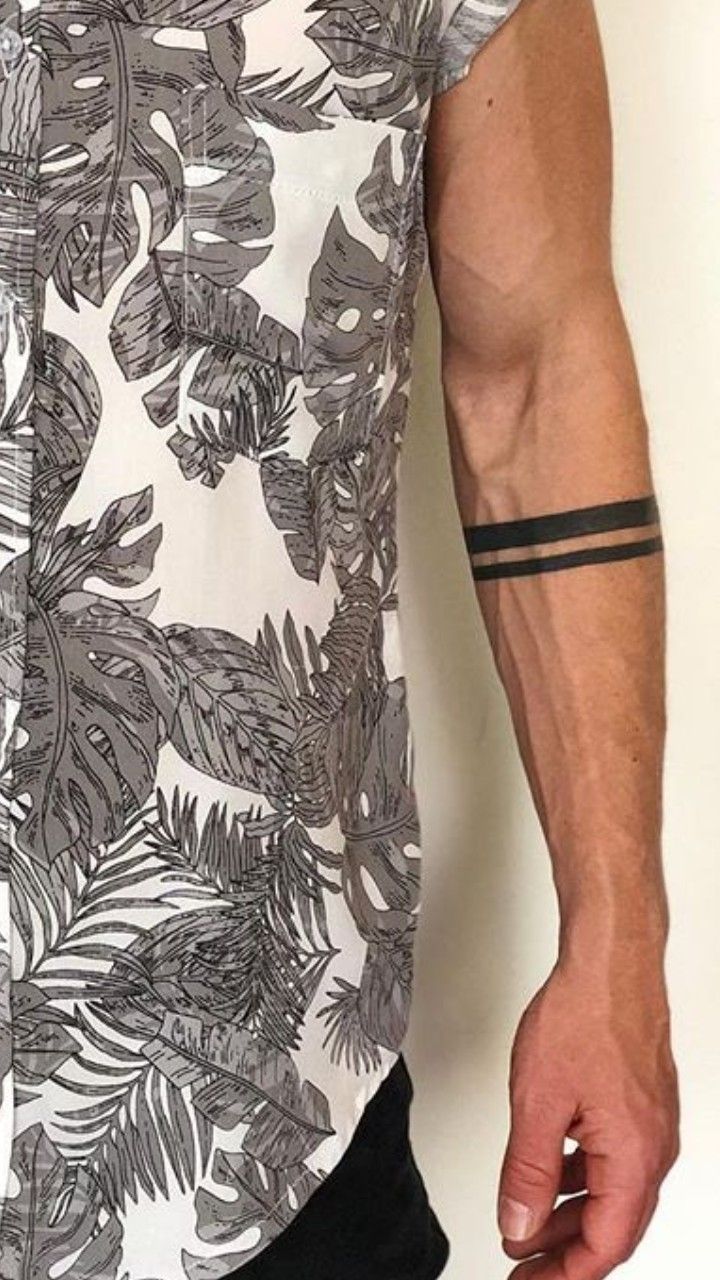 a man with tattoos on his arm wearing a shirt