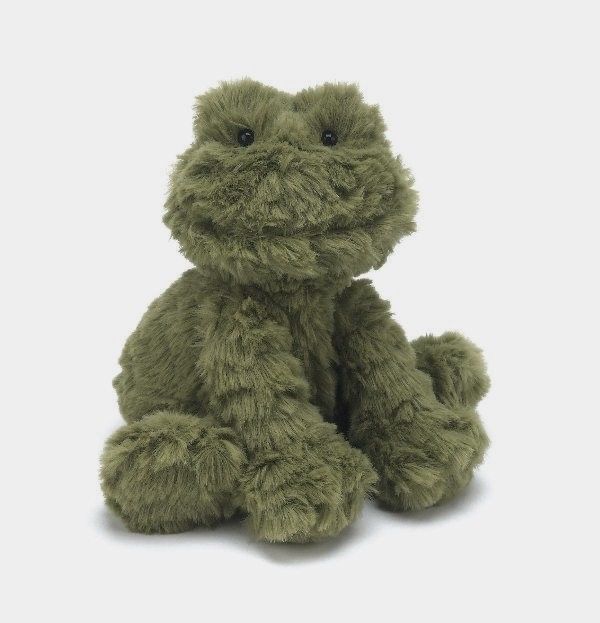 a green stuffed animal sitting on top of a white surface