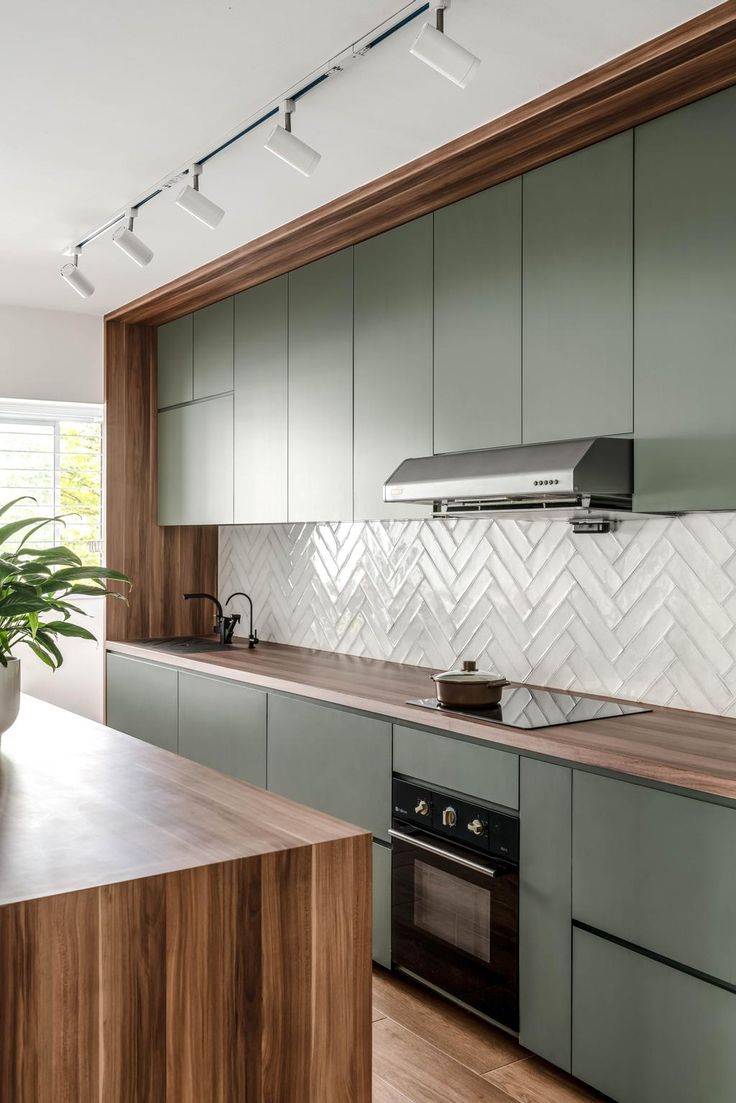 a kitchen with wooden counter tops and white tile backsplashes on the wall