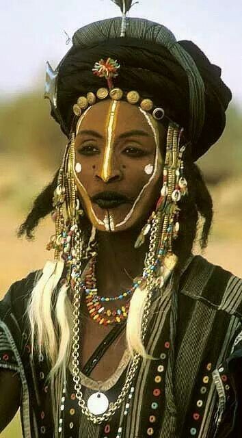 an african woman with long hair and beads