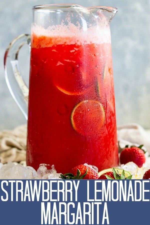 strawberry lemonade margarita in a pitcher with ice and strawberries