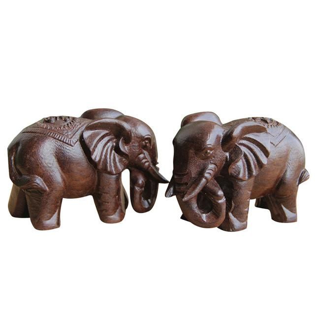 two wooden elephants standing next to each other