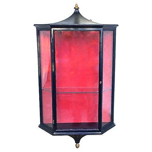 a red and black glass display case on a white background with gold trimmings