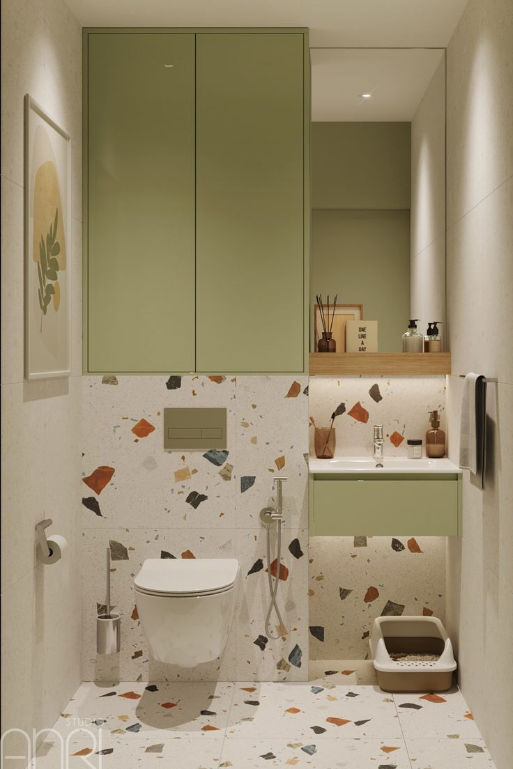 a bathroom with a toilet, sink and cabinet in it's center area that has colorful wallpaper on the walls