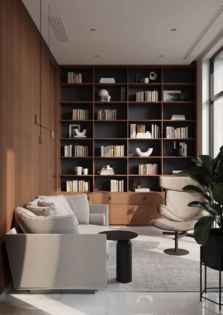 a living room filled with furniture and bookshelves next to a large glass window