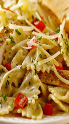 a white plate topped with pasta and meat