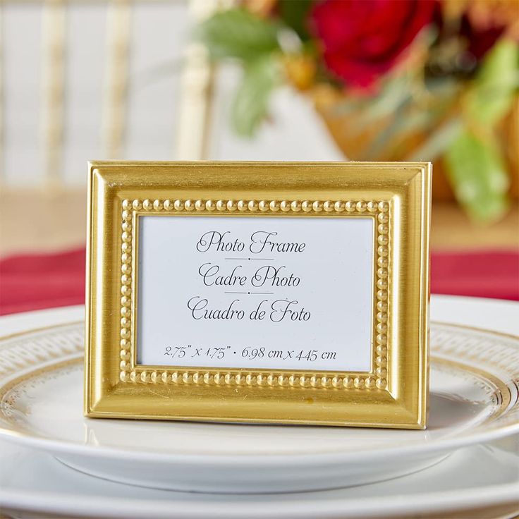 a gold frame sitting on top of a white plate