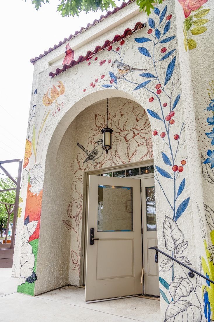 an entrance to a building with flowers painted on it