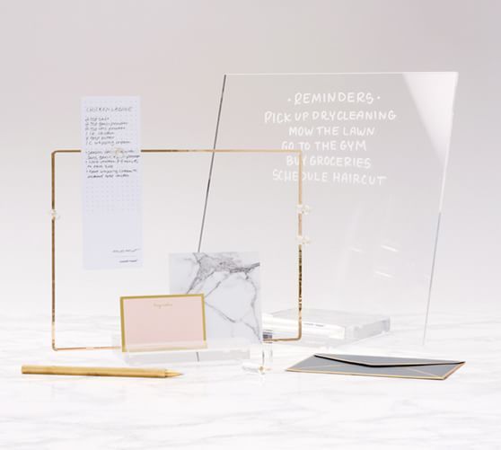 an award is placed next to a notepad and pen on a marble table top