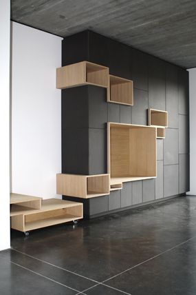 an empty room with wooden shelves on the wall and tile flooring in front of it