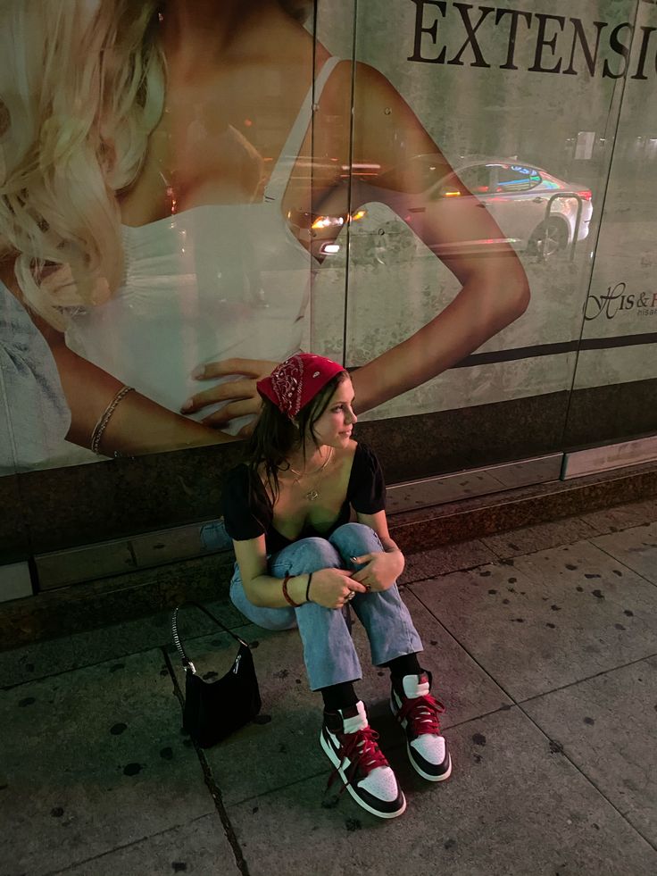 a woman sitting on top of a man's lap in front of a store window