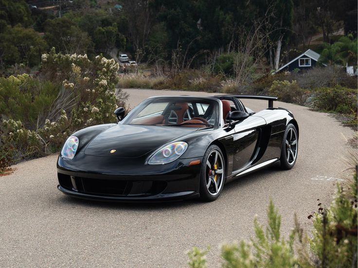 a black sports car driving down the road