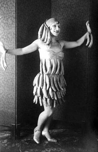 a woman in a banana costume poses for a photo with bananas on her head and arms