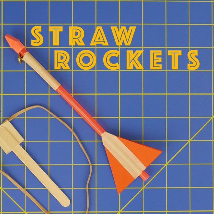 a blue cutting mat with an orange and white plastic toy on it that says straw rockets