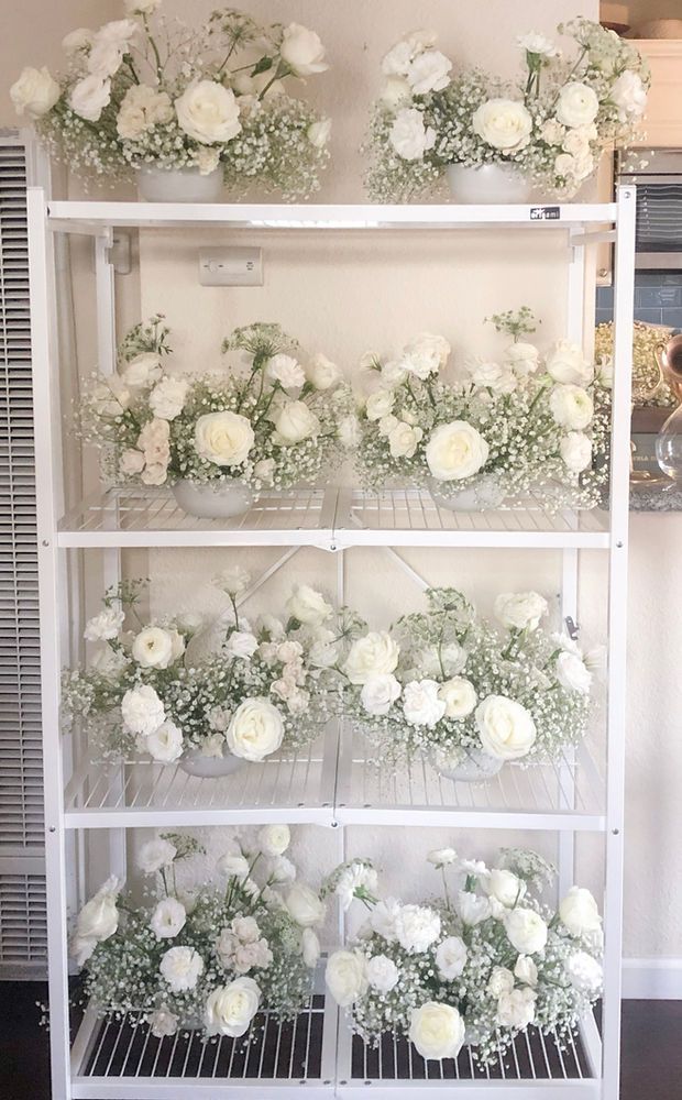 Baby's breath and white flower wedding centerpieces all lined up. Wedding Flower Trends, 2023 Weddings, White Roses Wedding, White Wedding Theme, Rose Centerpieces, Floral Trends, Wedding Floral Centerpieces, White Wedding Flowers, Flower Centerpieces Wedding