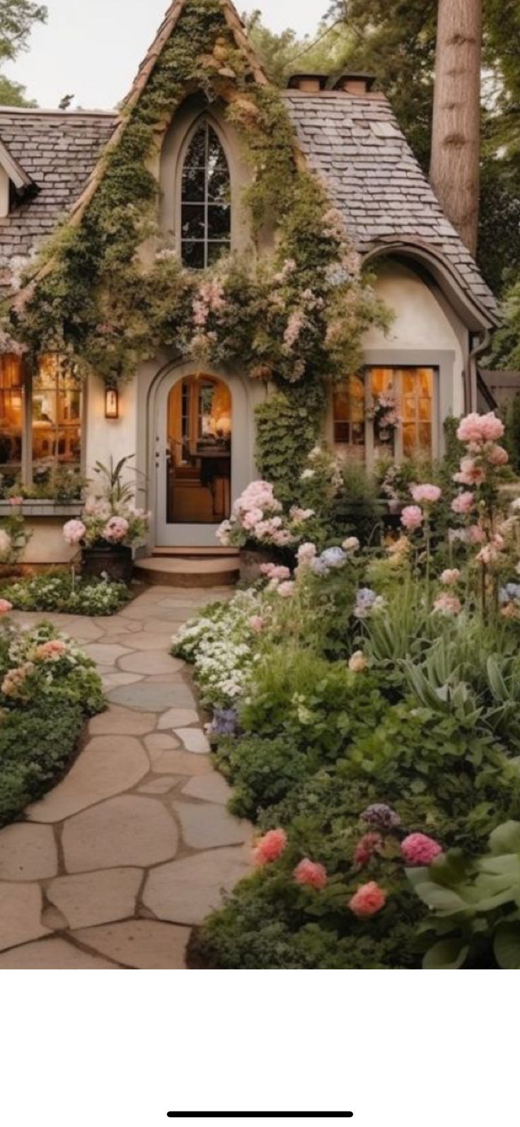 a house with lots of flowers and plants around it