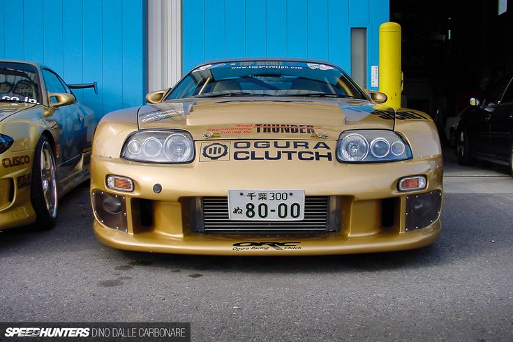 two cars parked next to each other in front of a blue garage door with the word turbo coutch written on it