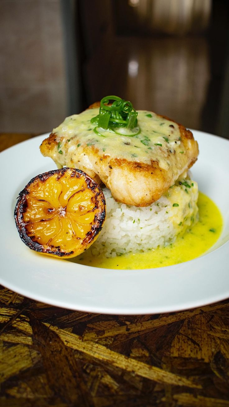 a white plate topped with chicken and rice