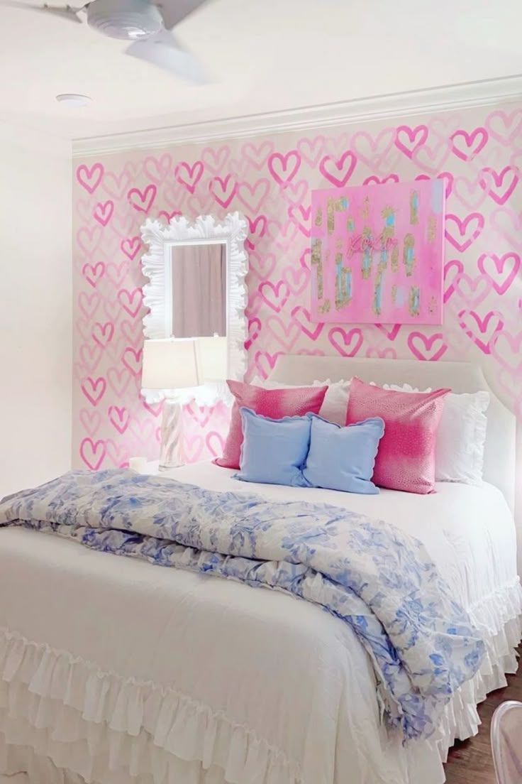 a white bed with pink hearts on the wall