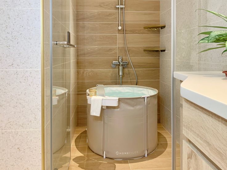 a bathroom with a tub, shower and sink in it's corner stall area