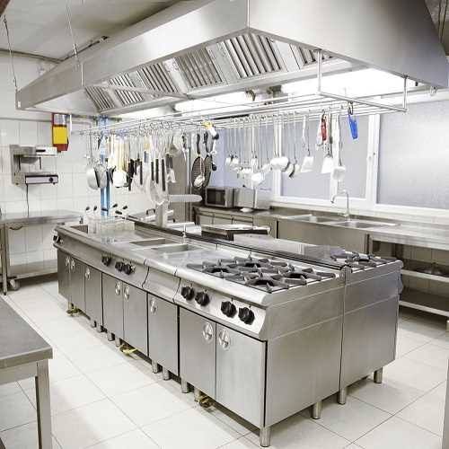 an industrial style kitchen with stainless steel appliances and white tile flooring, along with hanging utensils on the wall