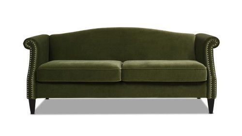 a green couch with studding on the armrests and back rests against a white background