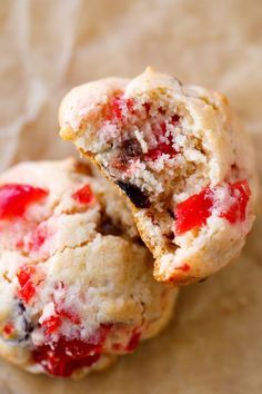 two strawberry muffins cut in half sitting on top of each other with one bite taken out