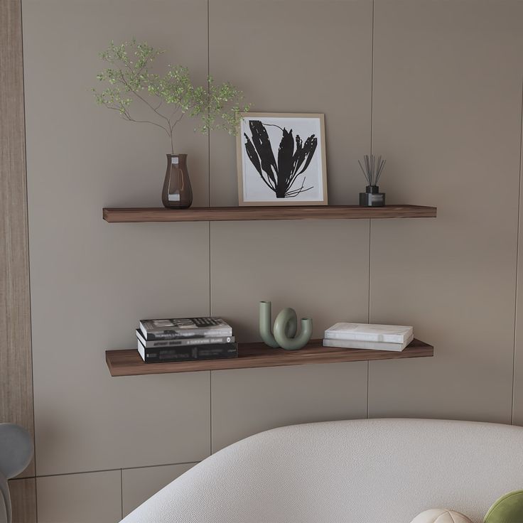 two floating shelves with books and vases on them in a living room setting,