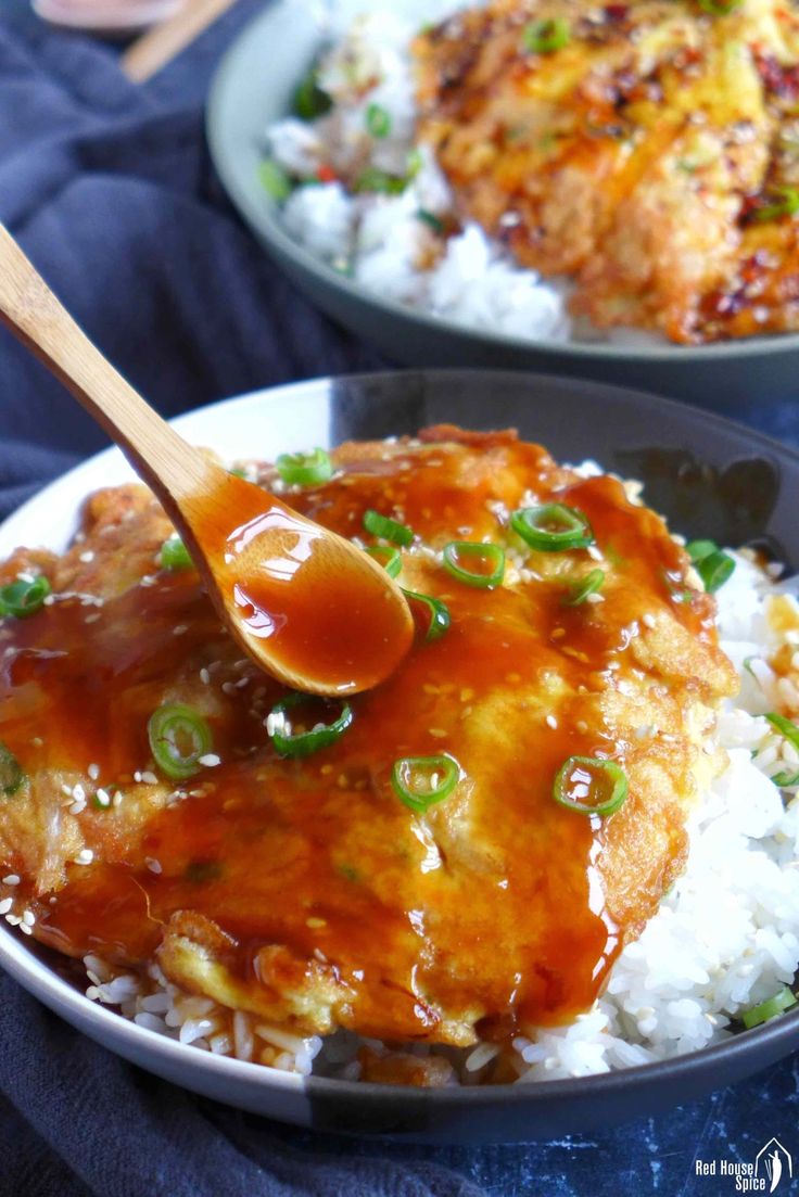 two bowls filled with rice and meat covered in sauce