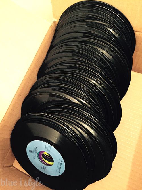 a box filled with lots of black plastic discs