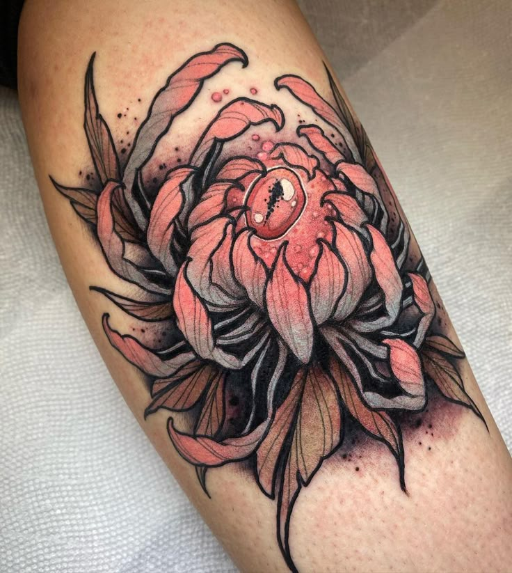 a close up of a flower on a person's leg