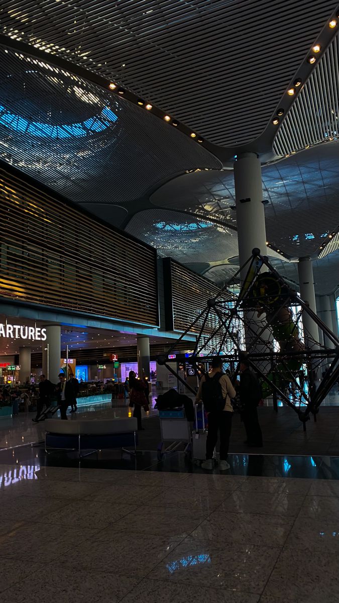 people are standing in the lobby of an airport