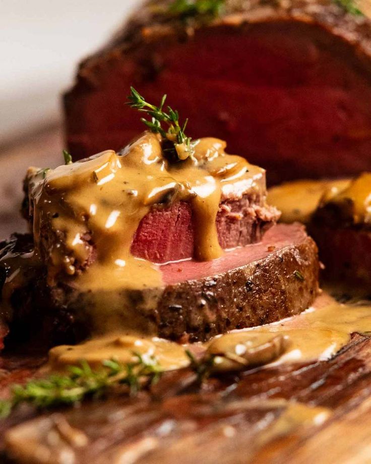 steak with mustard sauce and green garnish on top