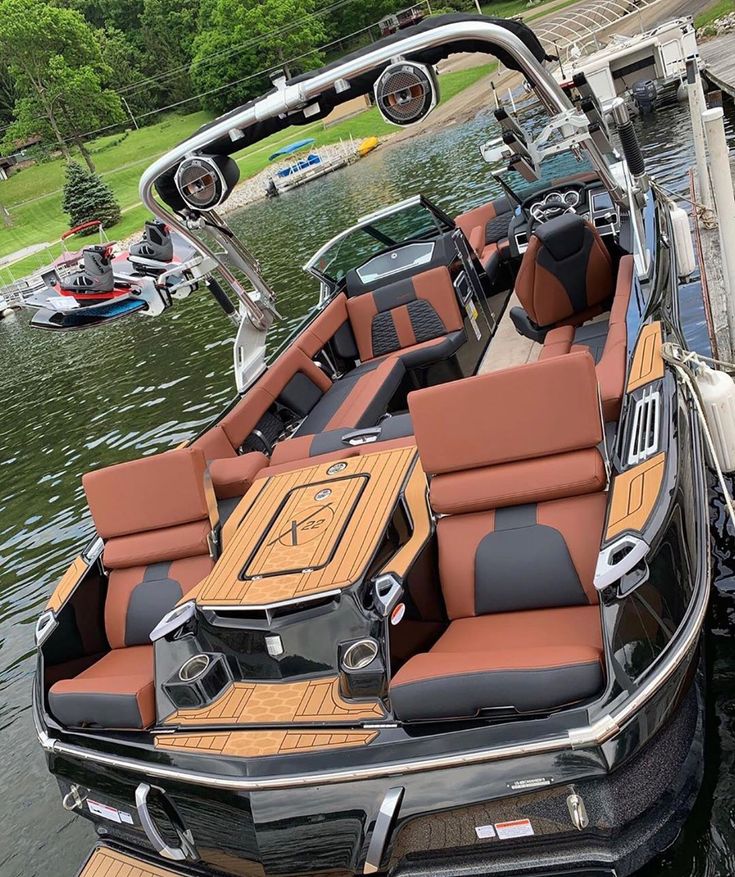 a boat is parked on the water with its seats down