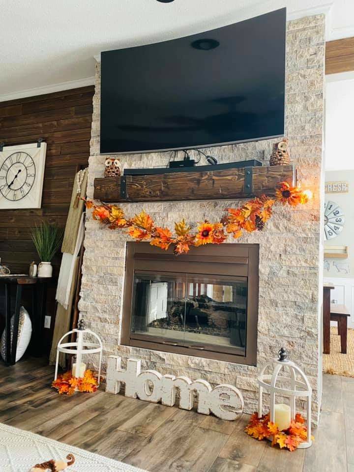 a living room filled with furniture and a flat screen tv mounted above a fire place