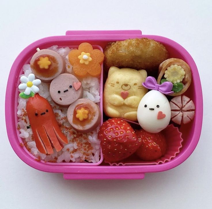 a pink plastic container filled with different types of food