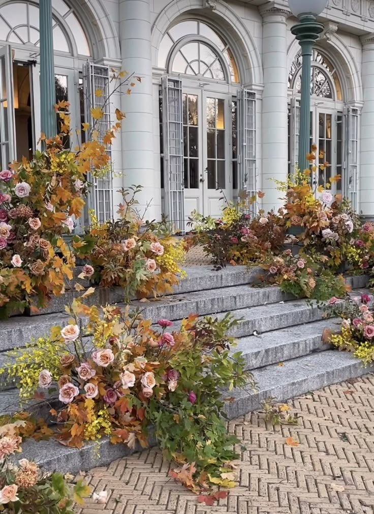 the flowers are blooming on the steps in front of the building